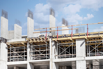 Construction of a monolithic reinforced concrete house. Modern building technologies. Construction of a modern multi-storey building.