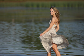 young woman in the water in a dress