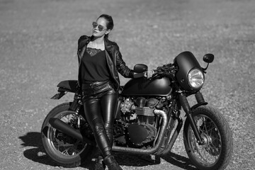 Obraz na płótnie Canvas young woman on a black motorcycle