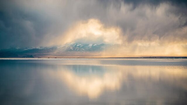 Time Lapse, Dark Clouds Moving Above Salt Flats With Mirror Reflection on Water. Bommeville Salt Flats, Utah USA