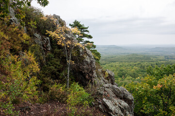 Autumn landscape: a rock on the background of a forest