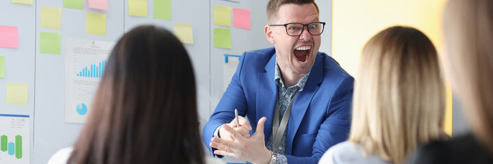 Emotionally screaming business coach conducts employee training. How to resist the rudeness of head