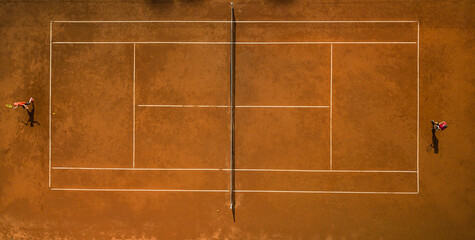 Tennis players on the court. Wide angle view from above with plenty of copyspace