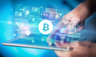 Close-up of a hand using tablet, currency concept