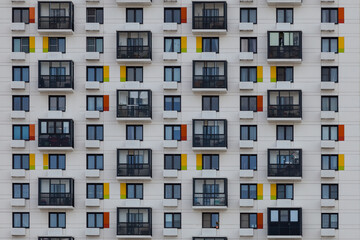 Fototapeta na wymiar Background image - geometric pattern of balconies and windows of the building