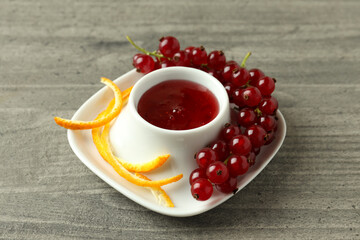 Cranberry sauce and ingredients on gray textured table