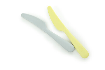 Plastic yellow and gray knives isolated on white background