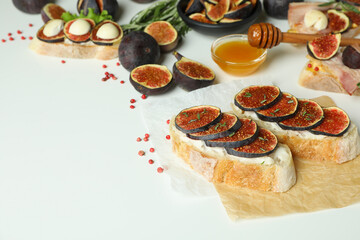 Concept of tasty food with bruschetta with fig on white background
