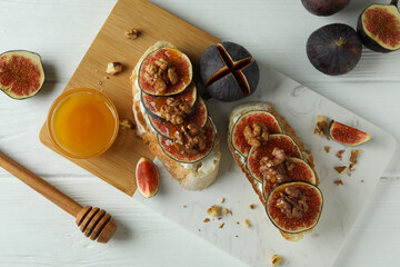 Concept of tasty food with bruschetta with fig on white wooden table