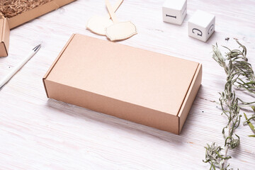 Brown carton cardboard box, on wooden table