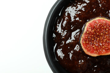 Bowl with fig jam and slice on white background