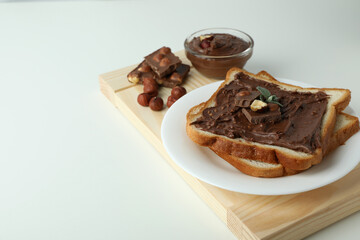 Concept of delicious food with chocolate paste on white background