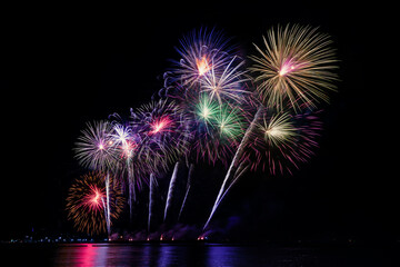 Colorful fireworks of various colors at night with celebration and anniversary concept