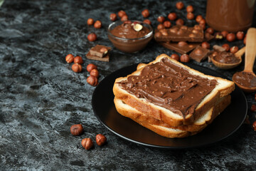 Concept of delicious food with chocolate paste on black smokey background
