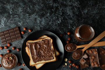 Concept of delicious food with chocolate paste on black smokey background