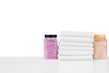 Composition of cosmetic bottles and towels isolated on white