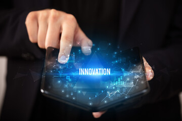 Businessman holding a foldable smartphone, business concept