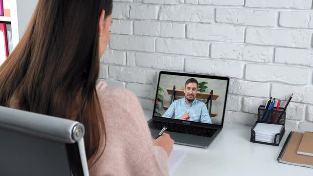 Woman at home study online video call webcam chat laptop listen teacher, writes in notebook. Smiling man tutor in computer screen talk teaches student remote webinar course lesson, distance education