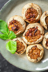 mushroom stuffed meat mushrooms baked fresh pork, beef, chicken or turkey meal snack on the table copy space food background rustic keto or paleo diet 