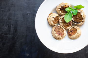 mushroom stuffed meat mushrooms baked fresh pork, beef, chicken or turkey meal snack on the table copy space food background rustic keto or paleo diet 