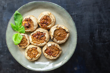 mushroom stuffed meat mushrooms baked fresh pork, beef, chicken or turkey meal snack on the table copy space food background rustic keto or paleo diet 