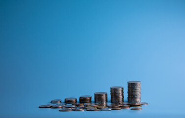 Coin stack on blue background for finance and business money saving ideas. with copy space and...