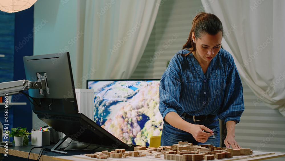 Poster architect holding maquette in hand using touch screen computer for construction development. woman e