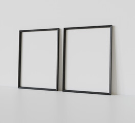 Two black frames leaning on white floor in interior mockup. Template of pictures framed on a wall 3D rendering
