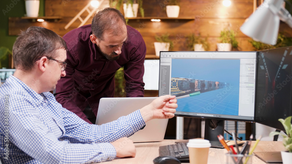 Poster graphic designer in game industry sitting at his office discussing video game graphic environment wo
