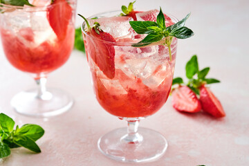 Strawberry cocktail drink with ice and oregano.