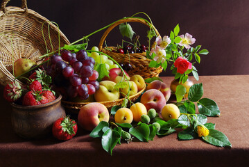 Classic still life with fruits, grapes and flowers. Assortment of delicious fruits.