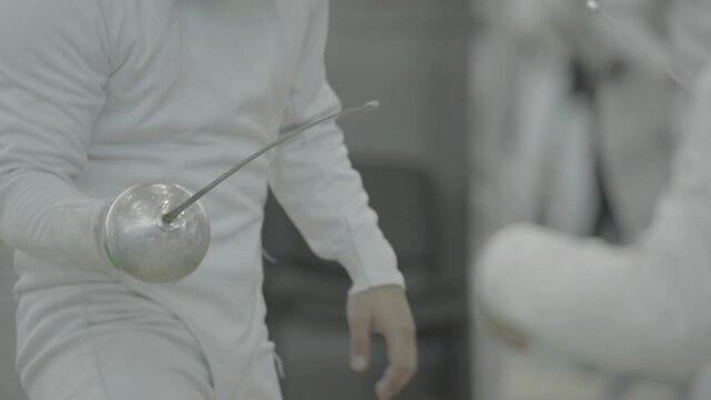 Swordsman with a sword during fencing competitions