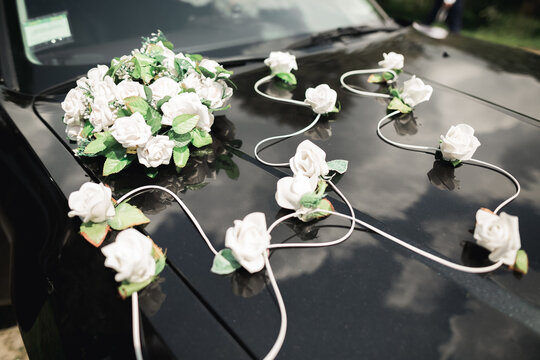 Close-up image of wedding car decoration with red and white flowers bouquet