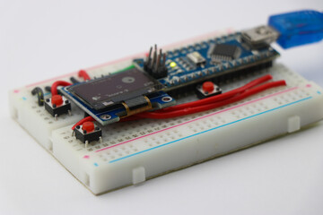 Prototype project built on breadboard with OLED display and programmable microcontroller, STEAM or STEM projects concept