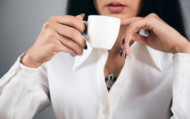 woman drinking coffee in office