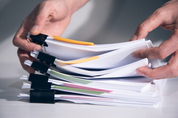 man holding stack of papers