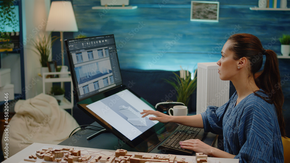 Poster young engineer using technology for construction design in office. woman working as architect with b