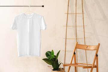 Fototapeta na wymiar Plain white cotton t-shirt on hanger for your design