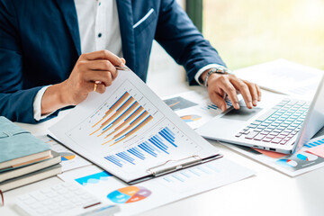Business man is checking and auditing the business performance with a help from his college....