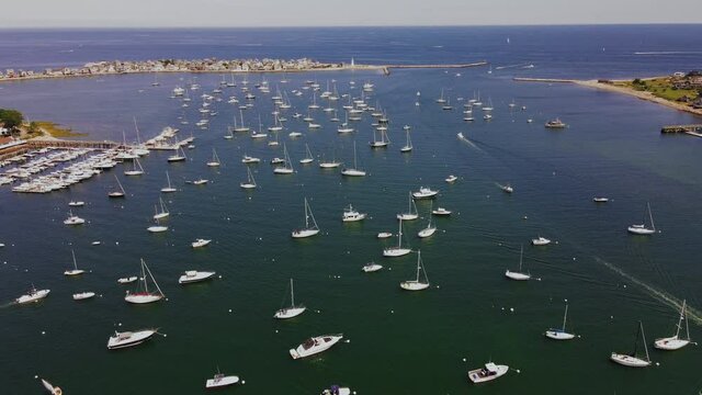 Aerial footage over Scituate Harbor, MA.  Slow decent showing multiple yachts and open ocean in distance.
