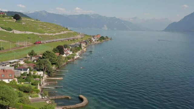 Aerial of train driving through beautiful Swiss coastline