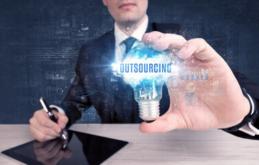 Businessman holding a light bulb, business concept