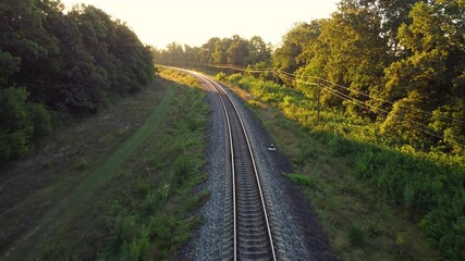 Fototapeta na wymiar Railway traffic from the shade of trees to the morning sunlight.