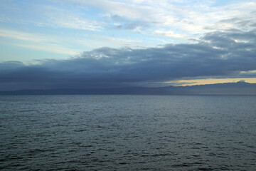 View of the coast of Morocco from the Atlantic Ocean. Sunrise. Morning. Clouds mountains horizon