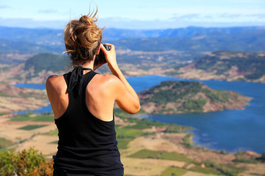 woman taking photo of beautiful panorama view