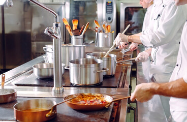 Chef cooking vegetables in wok pan. Shallow dof.