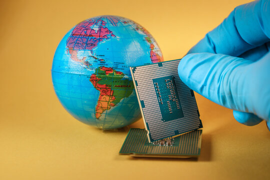 World globe and microprocessors against an orange background