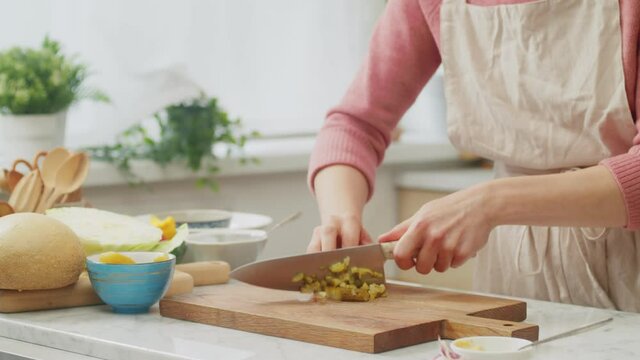 Chef cook chopping pickles for salad