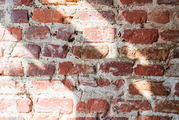 Background of brick wall texture and sunlight.Background of old vintage brick wall outdoors shot.
