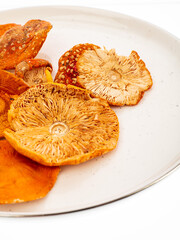 dried fly agaric mushroom on a plate on a white background